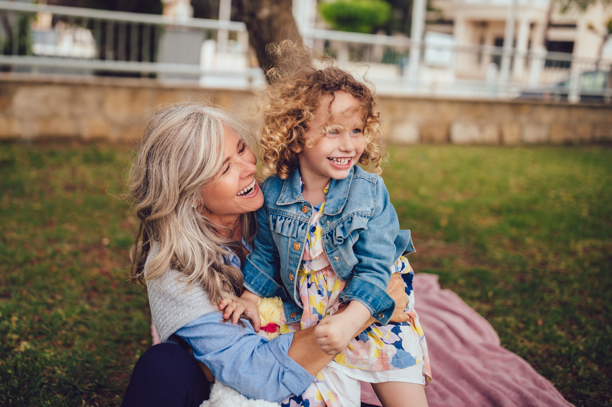 Loving grandmother and granddaughter playing and laughing together in garden