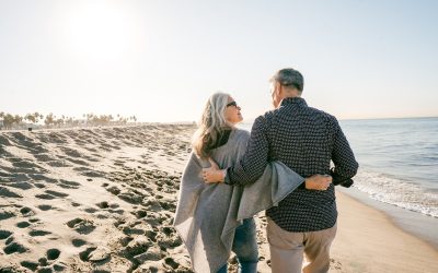 Middle-aged couple walking along the beach