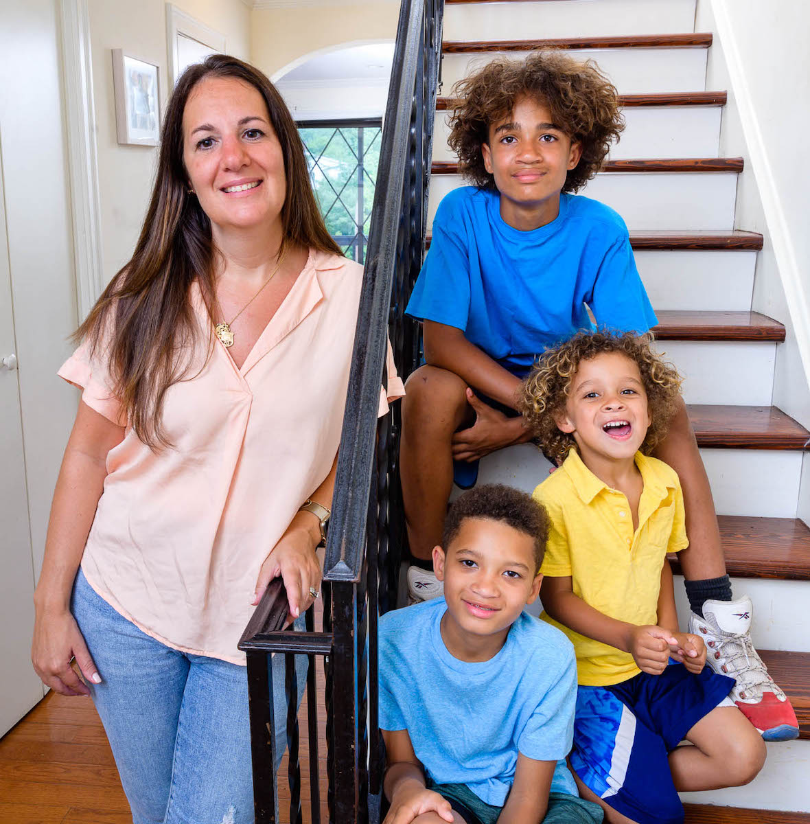 Sara Mathews Dixon on stairs with three sons