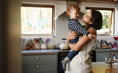 Mom holding son in kitchen