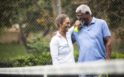 Retired Black couple playing tennis