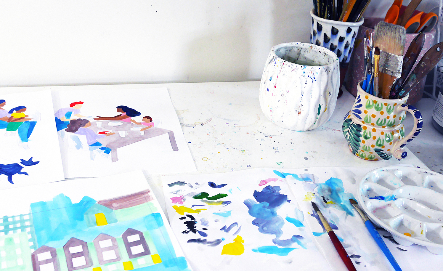 Artist Sirin Thada's desk with paintbrushes and illustrations
